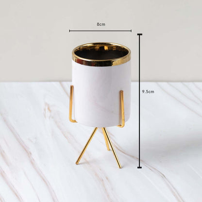 A white marble finish planter with a gold stand displayed with clear measurements of 8 cm width and 9.5 cm height for accurate size reference.