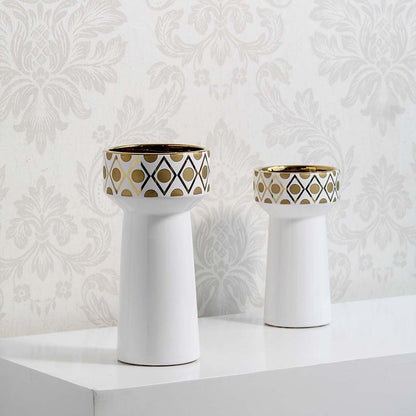 Collection of white ceramic vases with gold geometric patterns grouped on white background displaying modern decor set style.