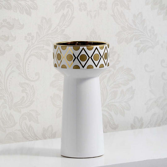 White tapered ceramic vase featuring a wide top collar with black and gold geometric patterns against damask wallpaper.