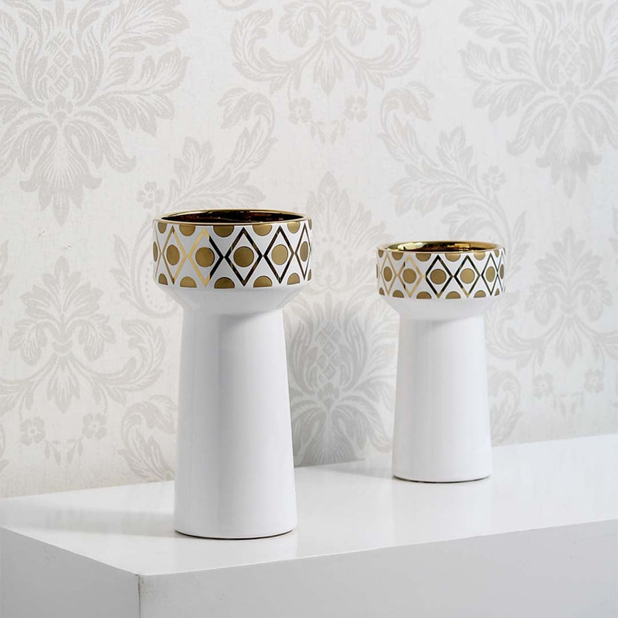 A stylish white and gold decorative vase displayed in a grouped setting highlighting its modern shape and refined detailing for home styling.