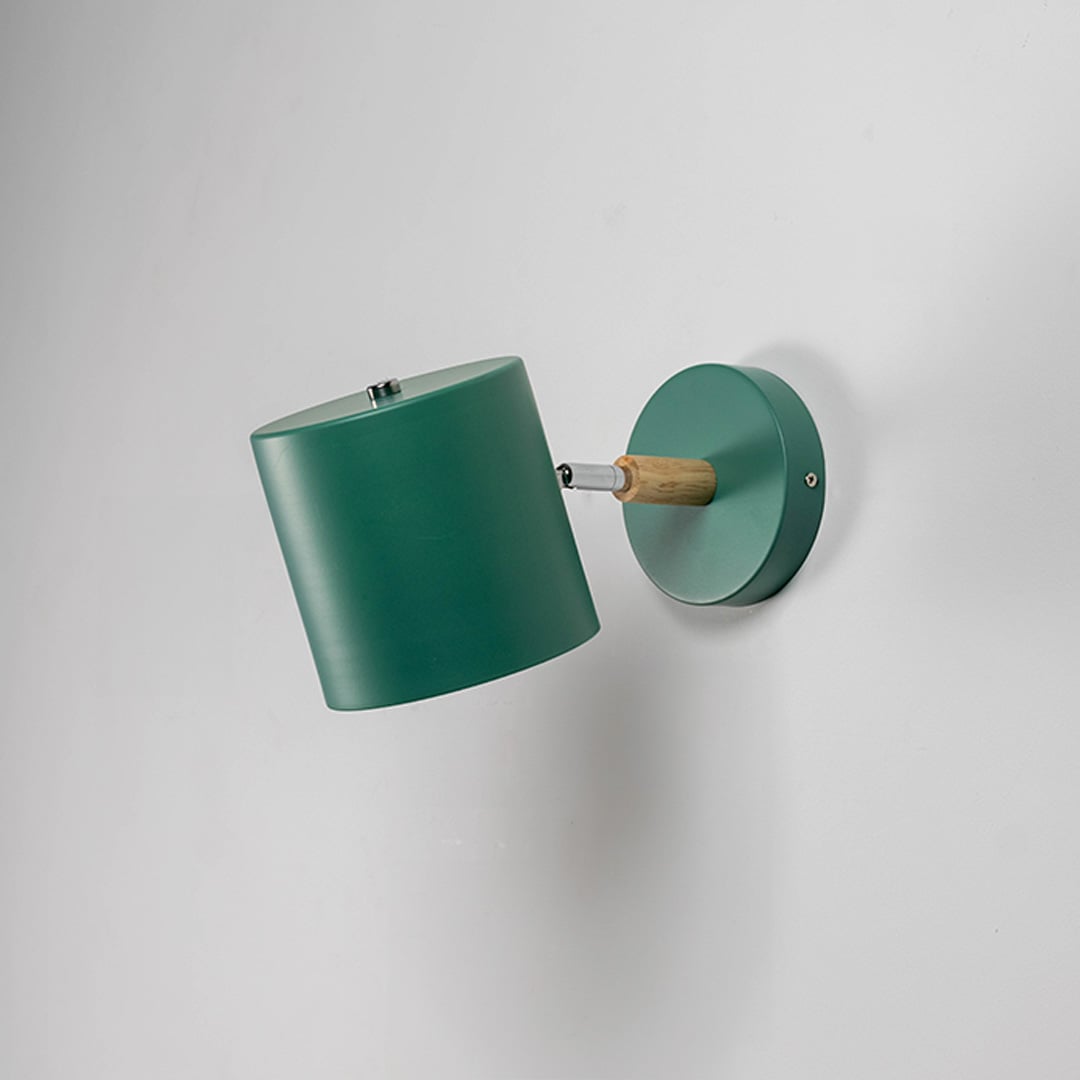 Green metal wall light shown unlit on white background with clean cylindrical shade for modern minimalist interior lighting.