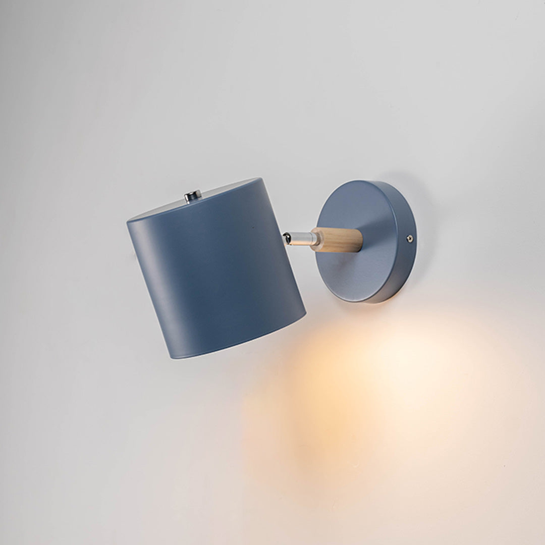 Contemporary blue metal spotlight wall light with warm glow for elegant modern interior lighting decor.