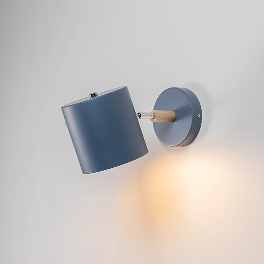 Contemporary blue metal spotlight wall light with warm glow for elegant modern interior lighting decor.