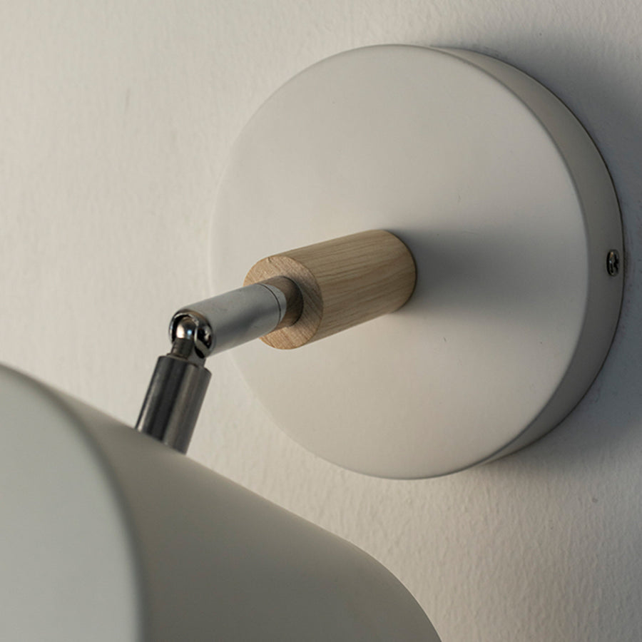 Modern white metal spotlight wall light with wooden accent detailing for stylish interior decor.