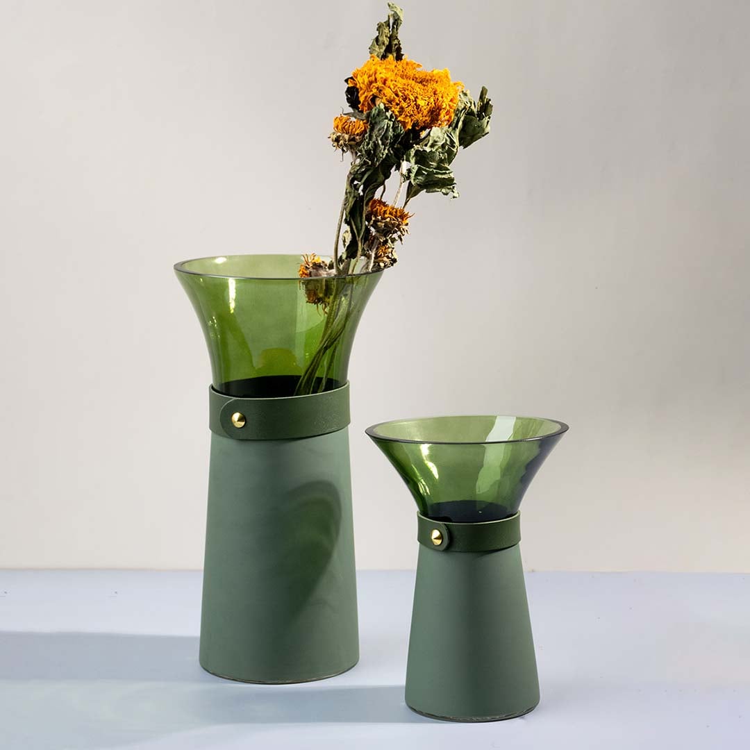 Set of green glass vases styled together as chic tabletop accents for modern and minimal decorative interiors.