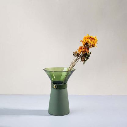 Green glass vase with wide mouth styled with yellow dried flowers adding charm to modern minimal lifestyle decor.