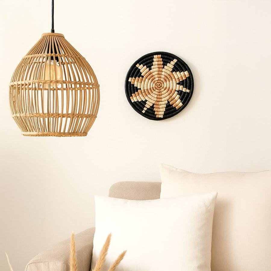 Black beige bamboo wall plate styled above beige sofa with rattan pendant adding boho charm to cozy living room.