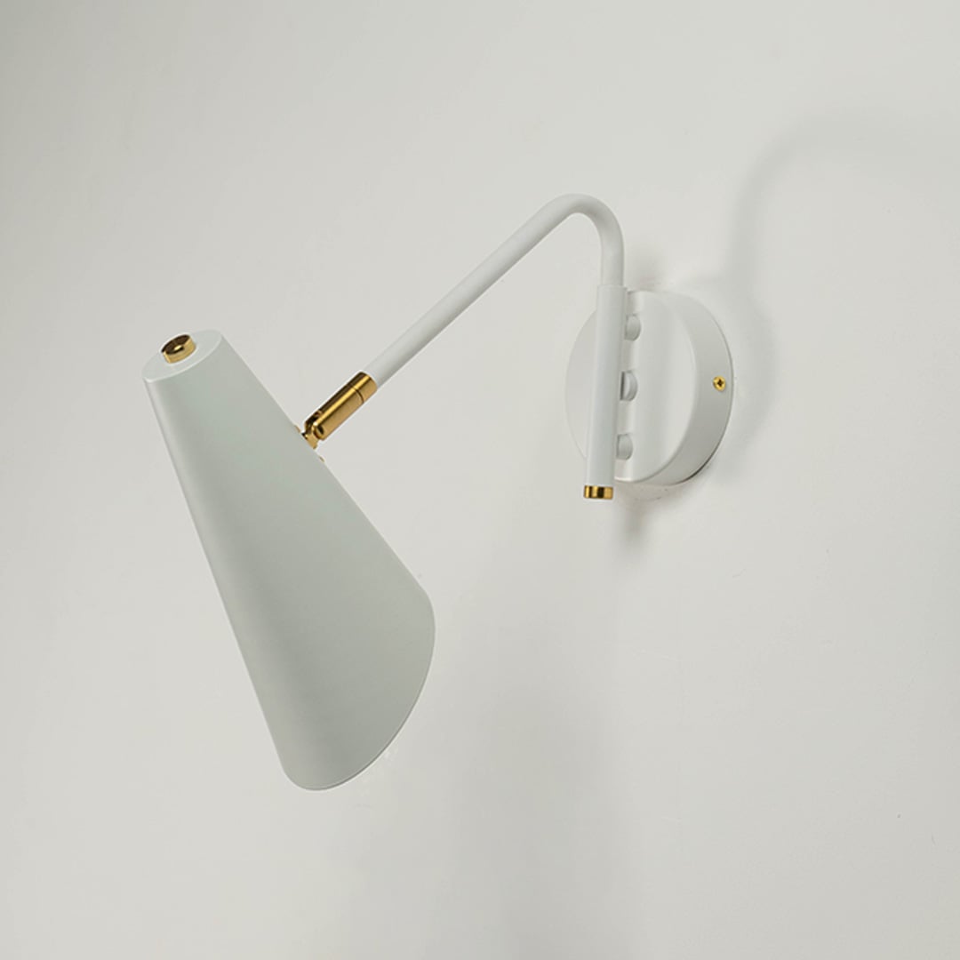 White cone wall light with brass fittings turned off on white wall displaying its clean and contemporary silhouette.