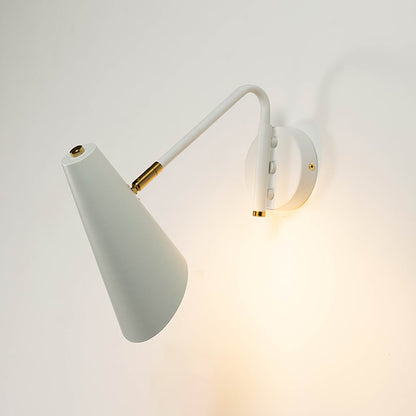 White cone wall light with brass detailing glowing softly against white wall adding refined charm and modern elegance.