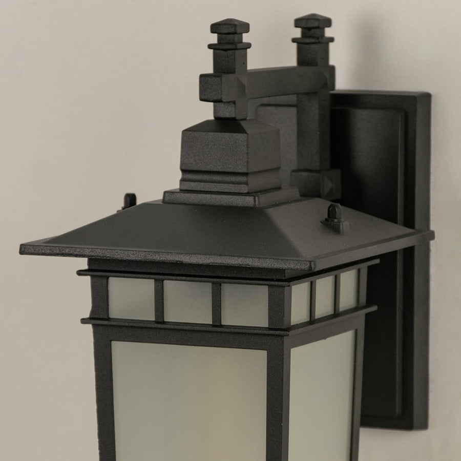Modern black outdoor wall lantern closeup image showing textured premium frame and frosted square glass panels for decor.