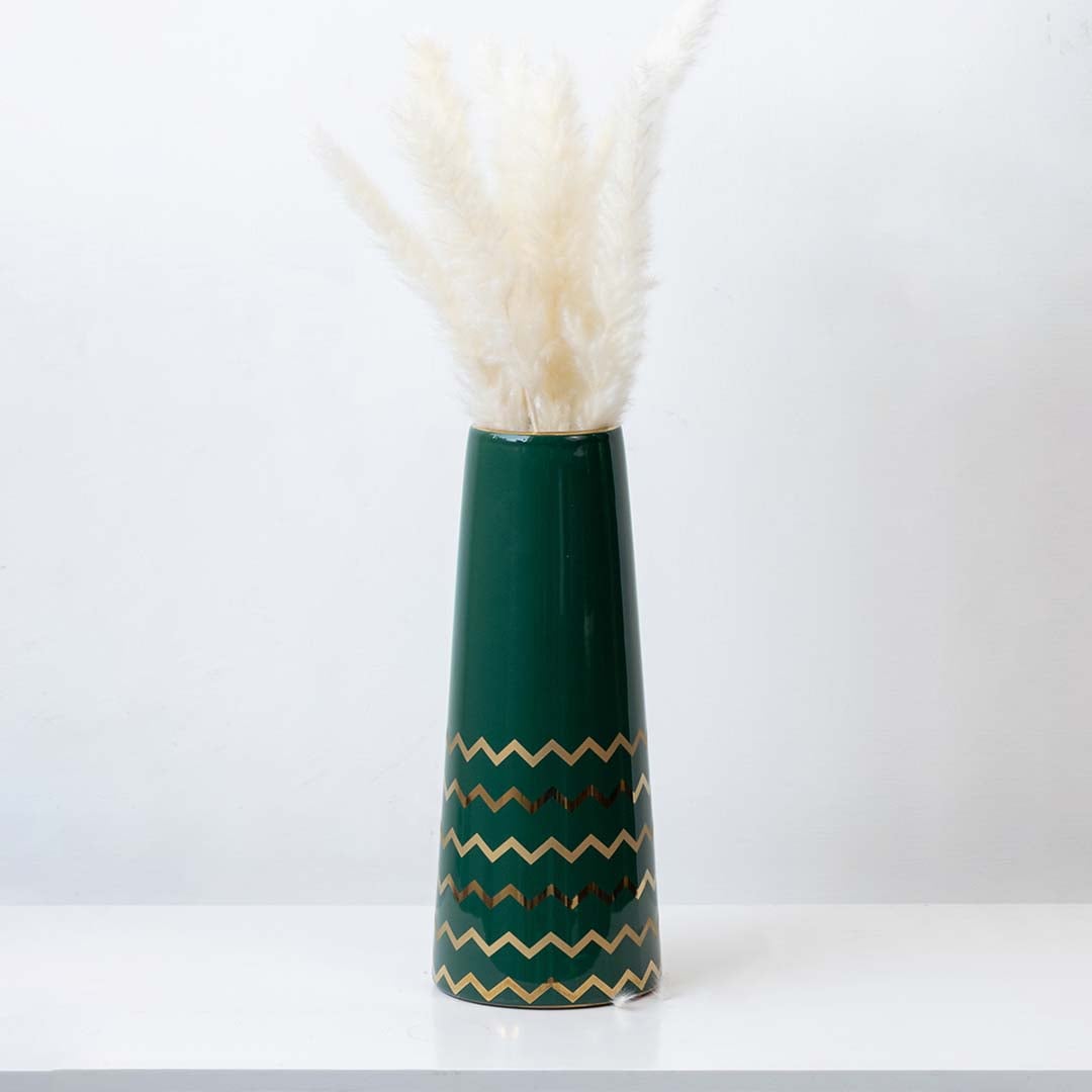 Elegant green ceramic vase with golden zigzag design styled with pampas grass for modern home decor.