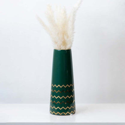 Elegant green ceramic vase with golden zigzag design styled with pampas grass for modern home decor.