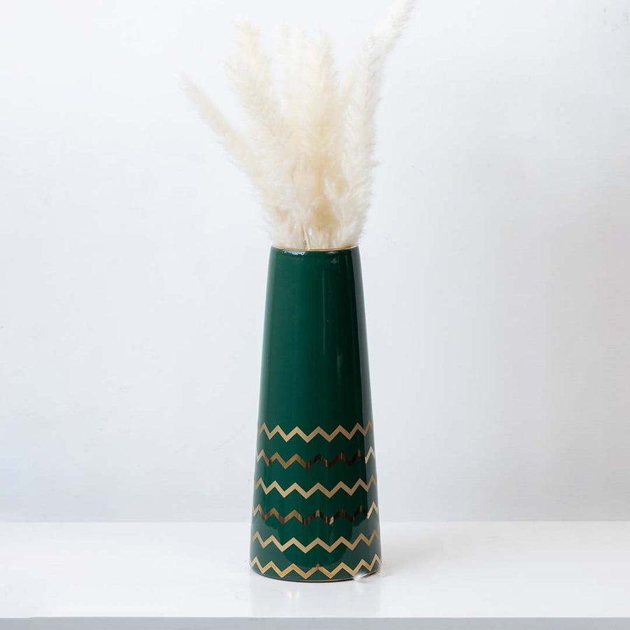 Elegant green ceramic vase with golden zigzag design styled with pampas grass for modern home decor.