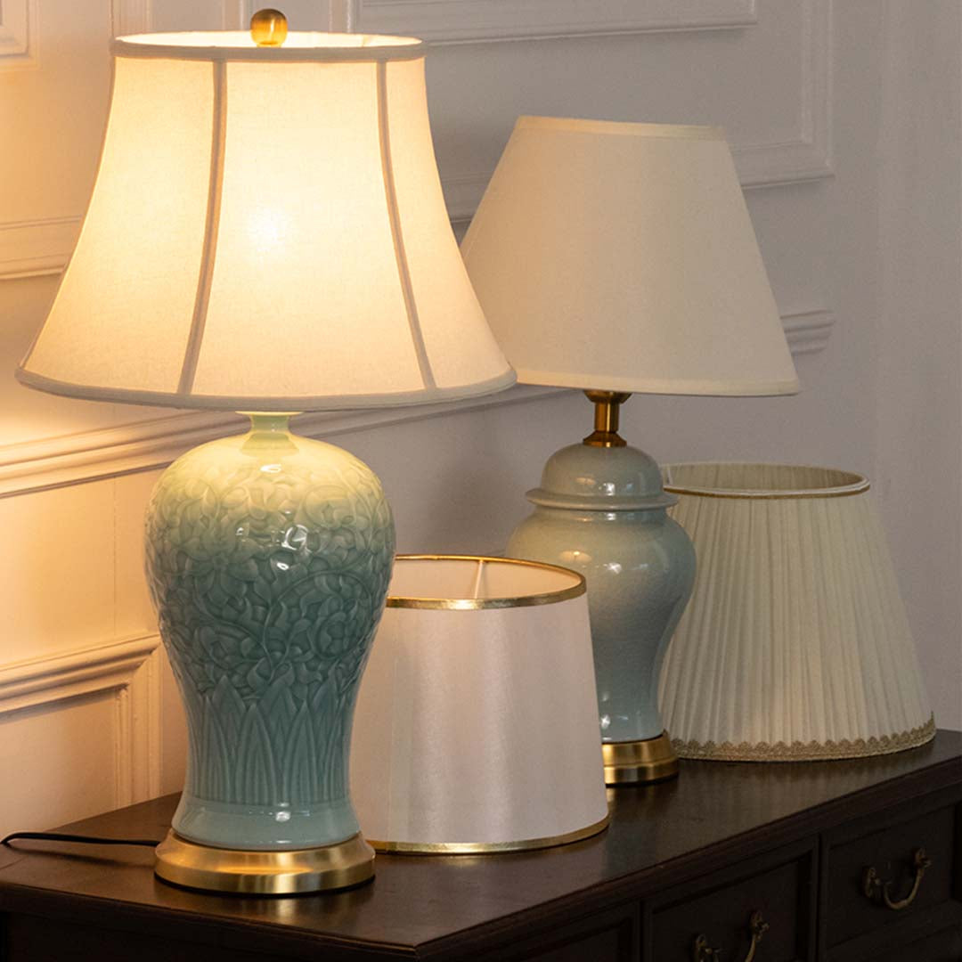 Turquoise ceramic table lamp with fabric shade displayed on a console table creating elegant traditional ambient lighting indoors.