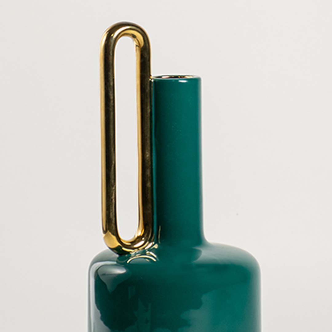 Closeup of teal ceramic vase showing its smooth glossy finish and metallic gold handle ideal for stylish modern home decor accents.