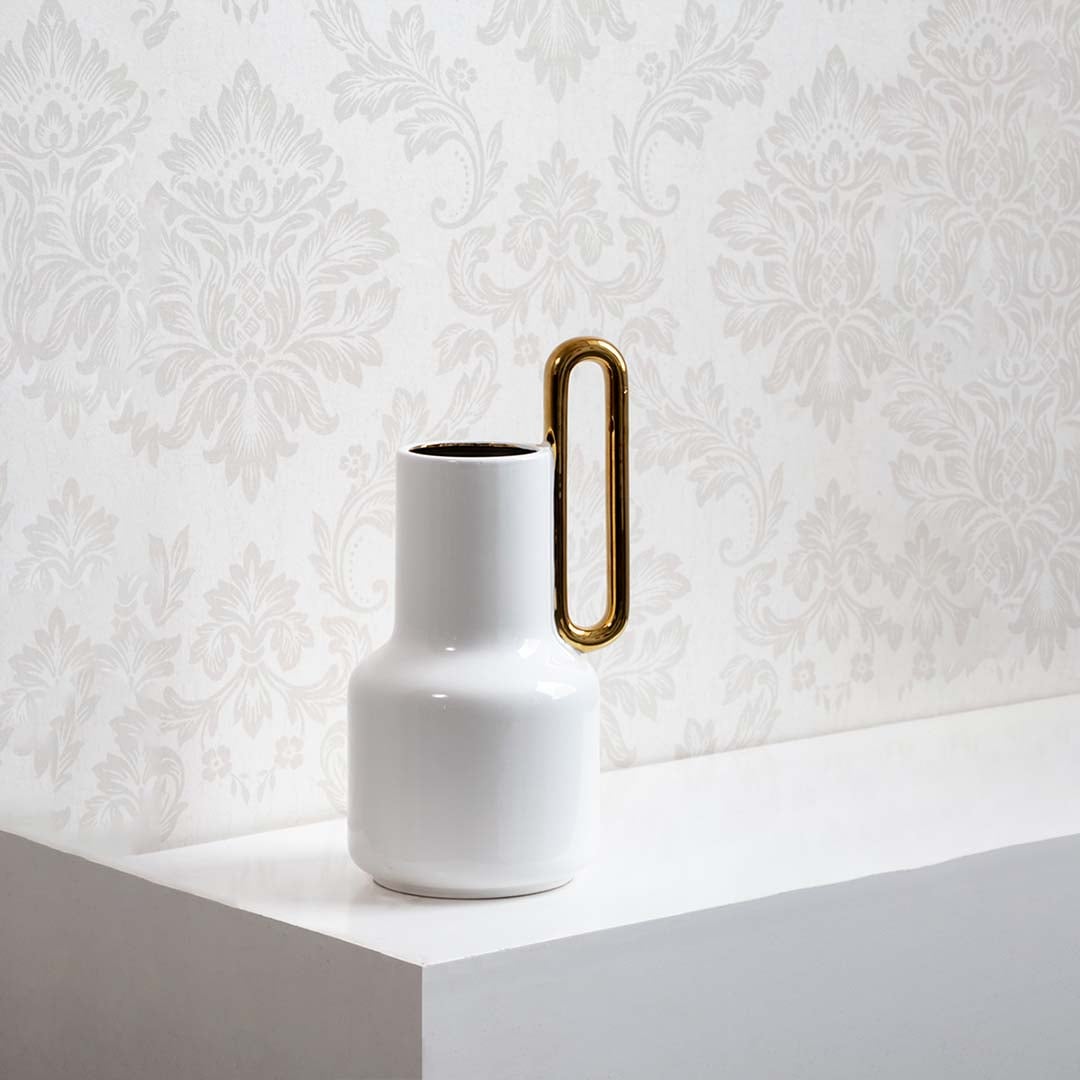 White ceramic vase with glossy finish and gold handle displayed on a clean white background ideal for minimal modern home styling.