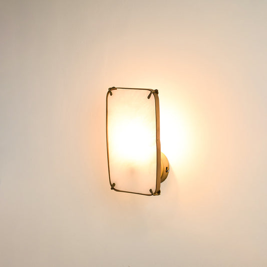 Modern marble wall light with warm ambient glow for stylish bedroom and luxury decor styling spaces.

