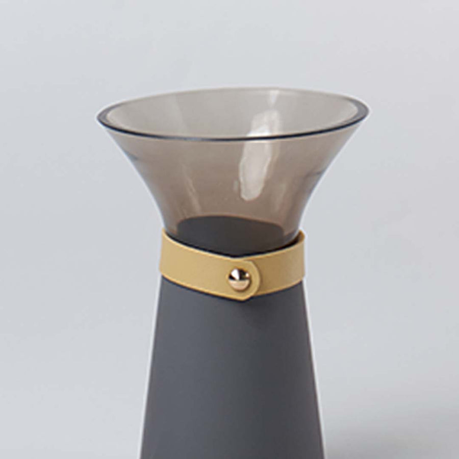 Closeup of small glass vase showing clear glass surface smooth curves and refined craftsmanship for modern interior table decor.