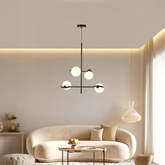 Black metal chandelier with white globes styled in a modern living room creating warm ambient lighting for elegant home decor.