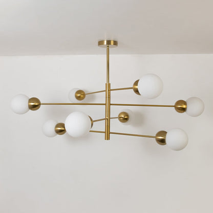 Table lamp style chandelier shown with the lights off on a clean white background featuring soft frosted globes and a sleek gold frame.