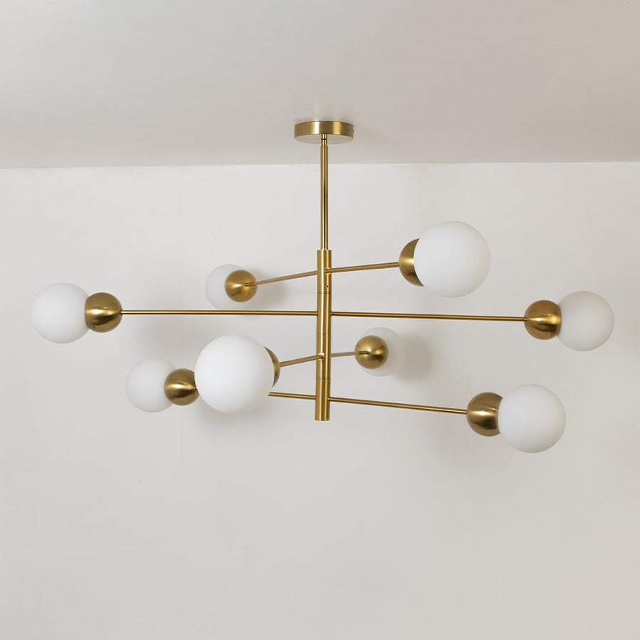 Table lamp style chandelier shown with the lights off on a clean white background featuring soft frosted globes and a sleek gold frame.