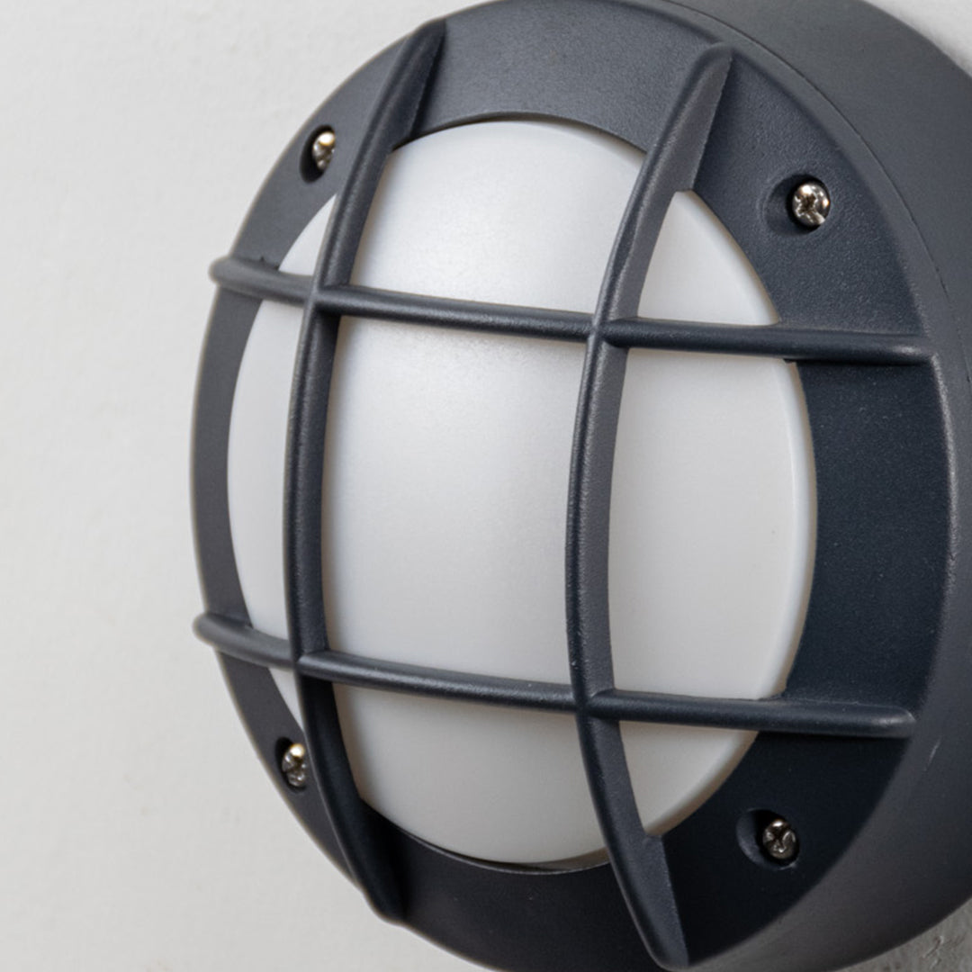 Modern black metal bulkhead wall light with frosted glass diffuser for stylish outdoor lighting decor.