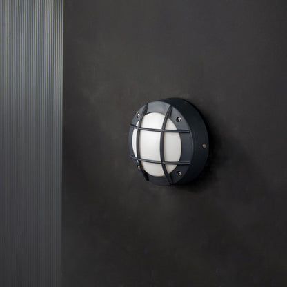 Black metal outdoor wall light with frosted dome shade shown turned off on white background for modern exterior decor.
