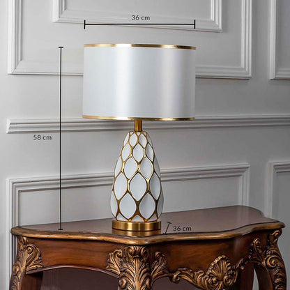 Gold ceramic table lamp with white shade shown with size 58cm height and 36cm width on white background for product details.
