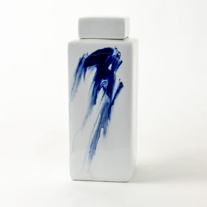 Tall white ceramic jar with bold blue brushstroke design displayed on clean background for artistic décor styling.