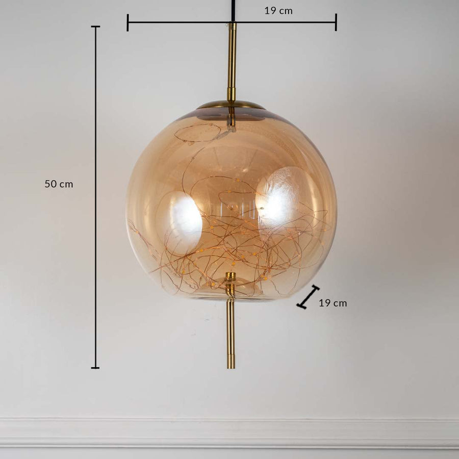 Amber glass globe pendant ceiling light with height 50 cm and diameter 19 cm shown clearly on off white background wall.