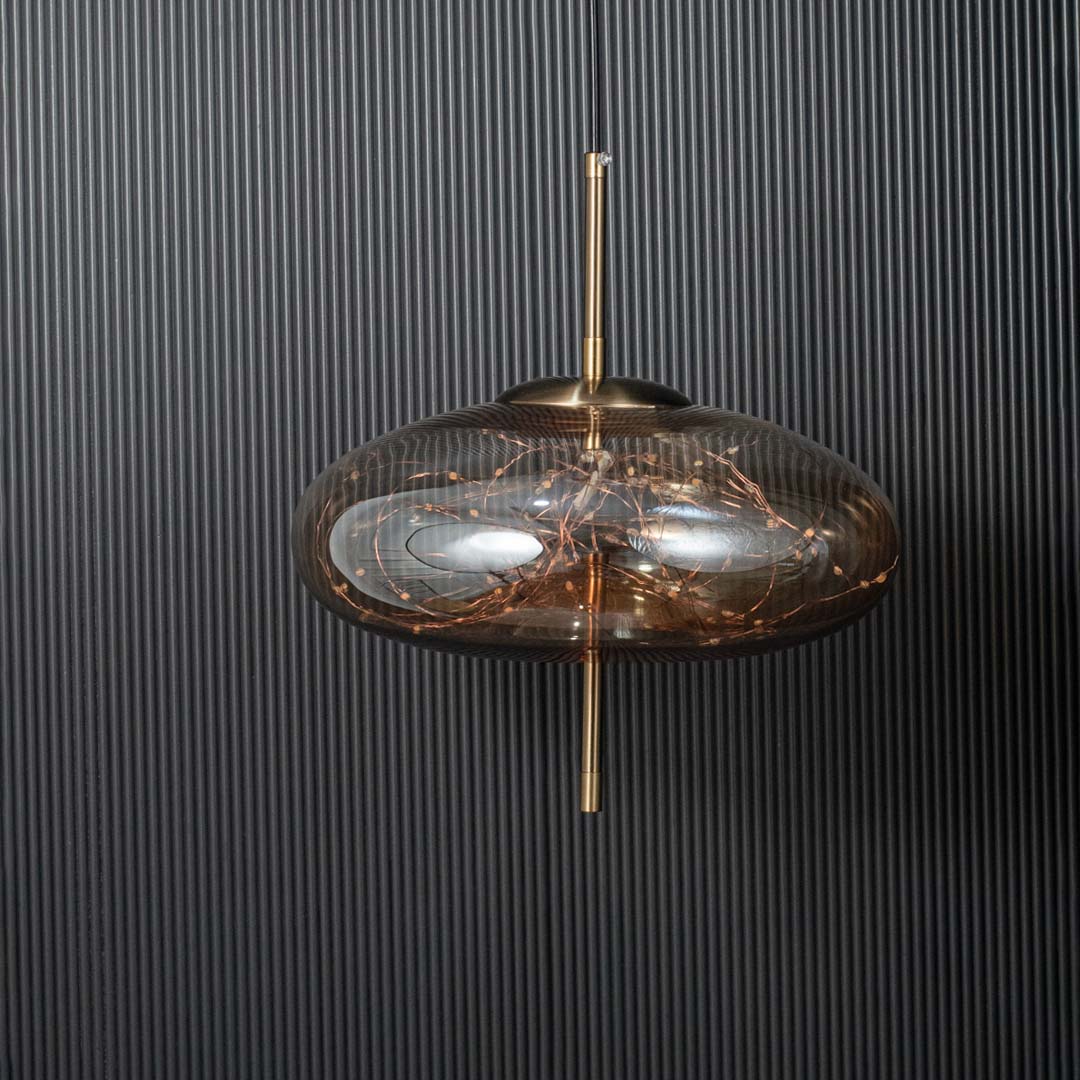 Pendant light shown switched off against a black ribbed background highlighting the glass shade metal rod and modern design details clearly.