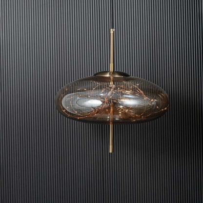 Pendant light shown switched off against a black ribbed background highlighting the glass shade metal rod and modern design details clearly.