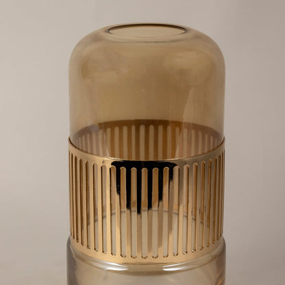 Closeup of amber glass vase showing fine ribbed gold detailing and smooth glossy texture.