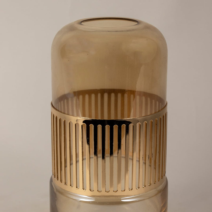 Closeup of amber glass vase showing fine ribbed gold detailing and smooth glossy texture.