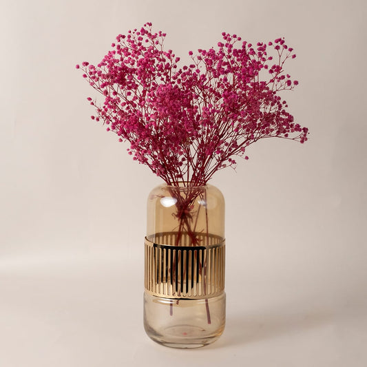 Elegant amber gold glass vase placed in a contemporary living space adding a touch of luxury decor.