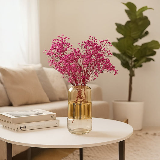 Amber gold glass vase with ribbed detailing styled on a wooden table for a modern luxury home look.