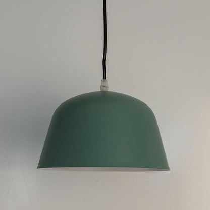 Matte green dome pendant light off white featuring clean dome shape perfect for kitchens dining rooms or workspaces.