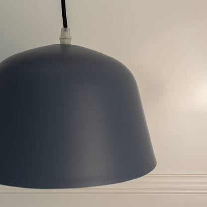 Closeup of matte blue dome pendant light emphasizing smooth matte texture and minimalist curved design.