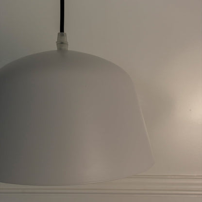 Macro shot of matte white dome pendant light focusing on its seamless smooth finish and elegant craftsmanship.