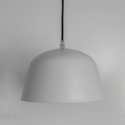 Matte white dome pendant light off white background showing smooth curved shade with minimalist finish and elegant design.