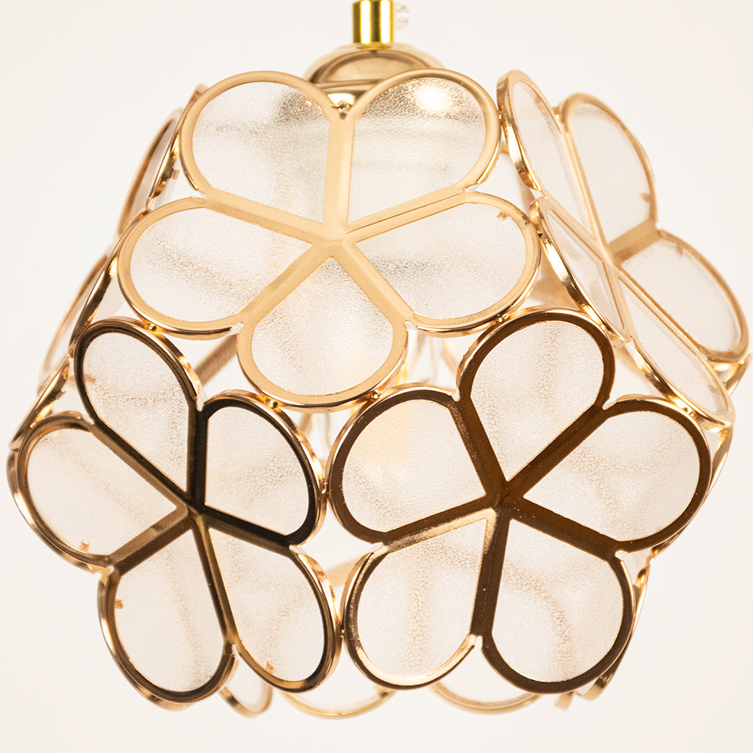 Gold metal geometric pendant light closeup showcasing artistic frame for luxurious modern ceiling lighting decor.