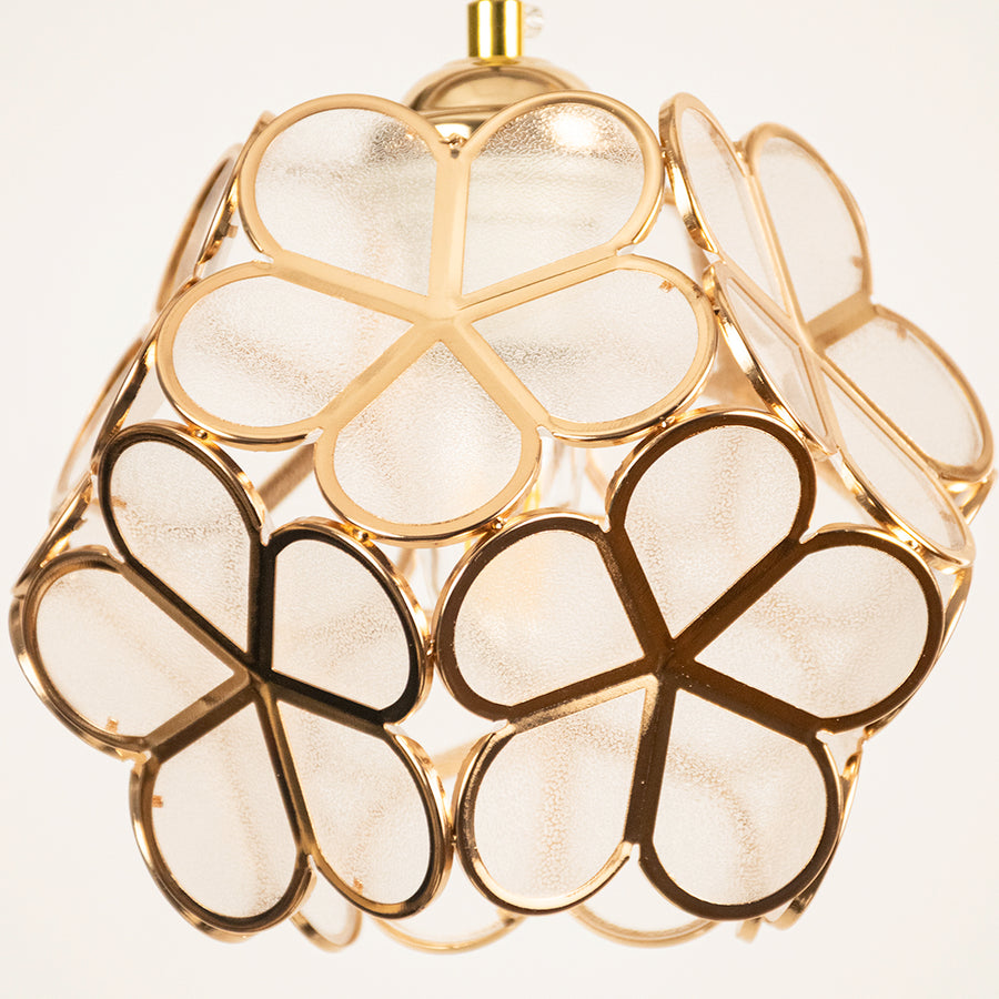 Gold metal geometric pendant light closeup showcasing artistic frame for luxurious modern ceiling lighting decor.