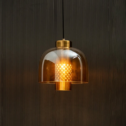 Amber glass pendant light glowing warmly with gold metal accents for luxurious indoor ceiling decor.