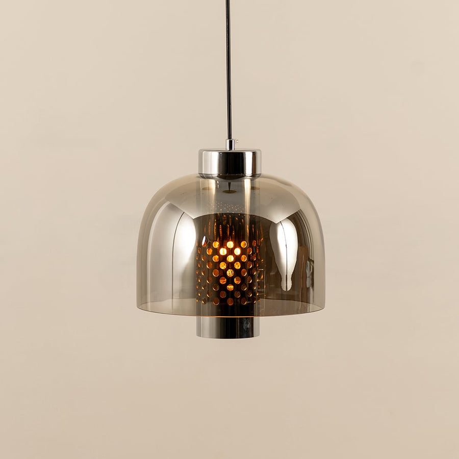 Smoke glass pendant light illuminated to display elegant ceiling lighting with contemporary decorative appeal.