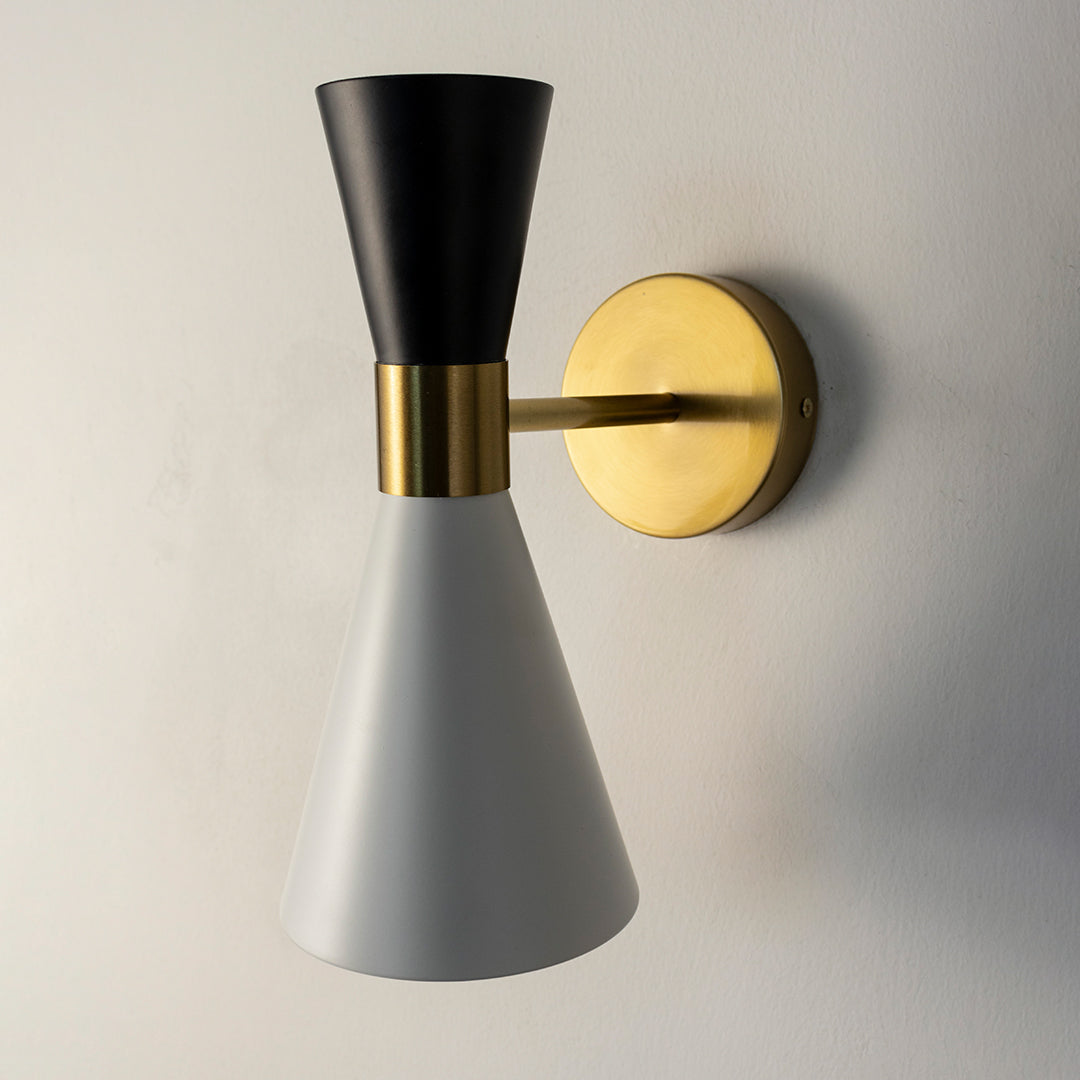 Modern black and gold metal wall light with cone shade for stylish bedroom hallway and living room decor spaces.

