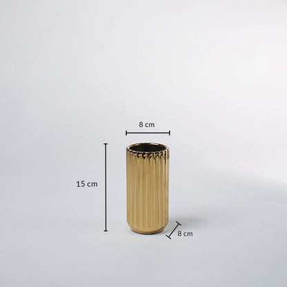 A gold ribbed vase shown with measurements of 15 cm height and 8 cm width clearly presenting its compact decorative size in a clean layout.
