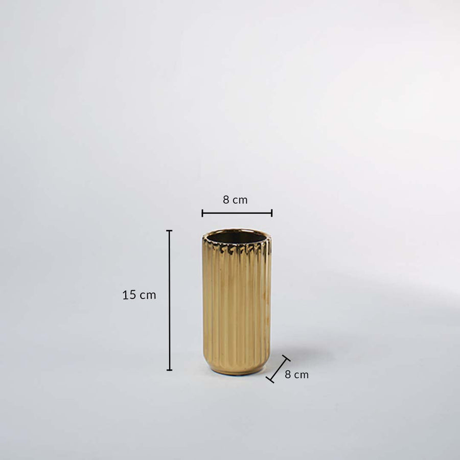 A gold ribbed vase shown with measurements of 15 cm height and 8 cm width clearly presenting its compact decorative size in a clean layout.