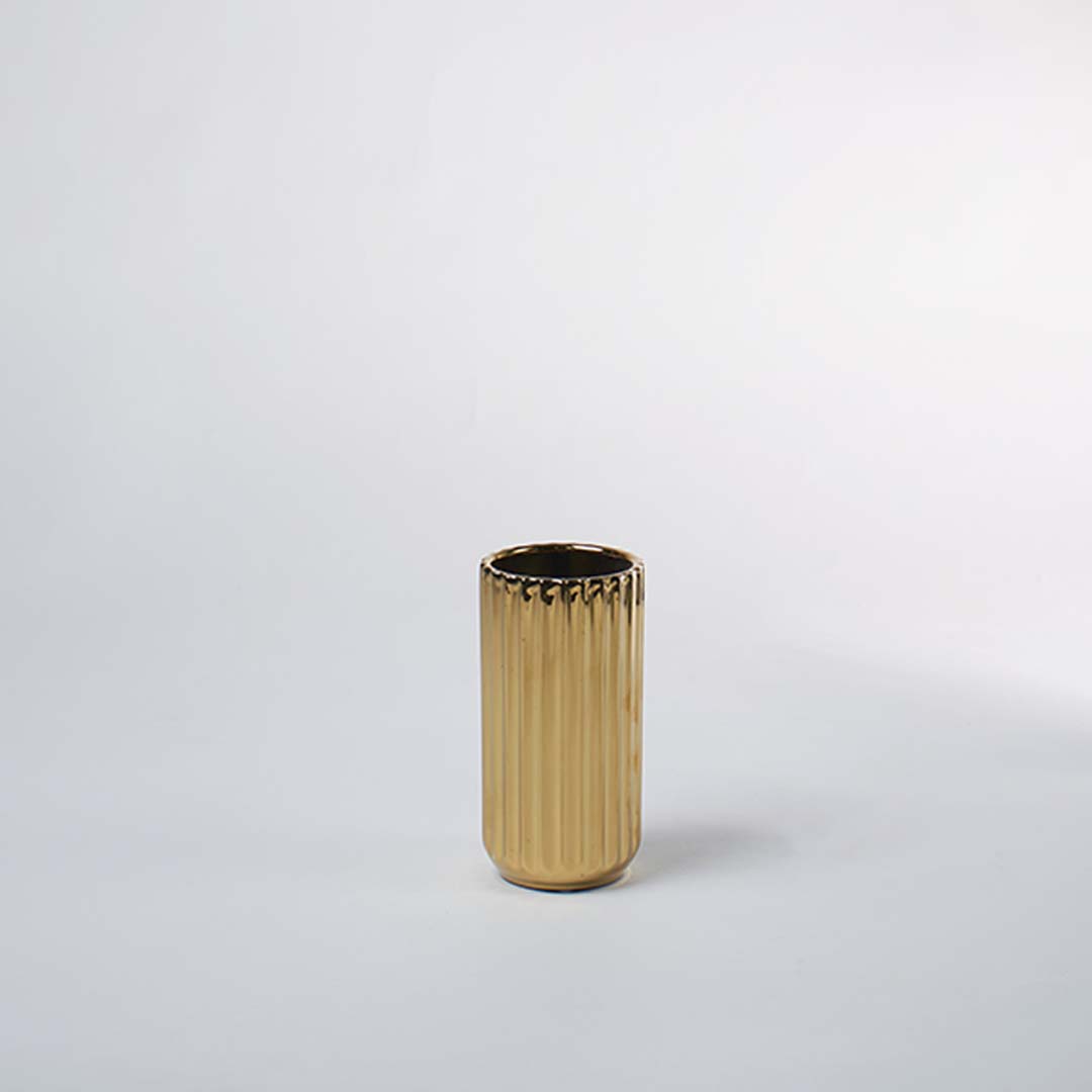 Gold metal decorative planter pot with ribbed texture for contemporary tabletop plant styling and home decor.