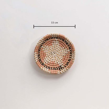 Handwoven wicker basket wall decor in beige pink and black woven pattern showing 15 cm size measurement on white.