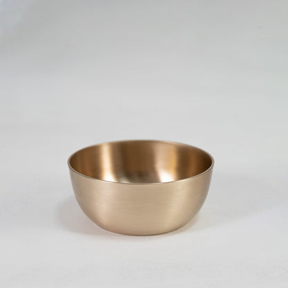 Plain brass tumbler with cylindrical shape and matte metallic finish displayed upright on clean white background.